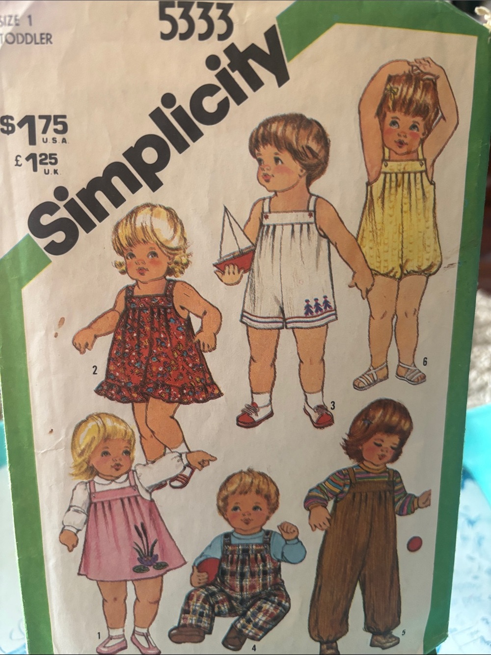 Simplicity pattern for toddler overalls, dresses, and a bubble suit in size 1